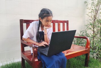Student girl sitting enjoy life on the bench, study online with laptop, e-learning class meeting