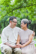 © eastfenceimage - Happy old couple sitting on chairs in outdoor park