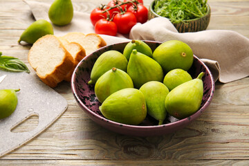 Composition with fresh green figs on wooden background