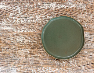 Wall Mural - Empty modern ceramic plate on wood table background ,top view