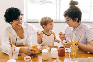 Wall Mural - Happy family painting Easter eggs