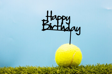 Wall Mural - Tennis ball with Happy Birthday sign on white background