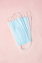 Close Up Stack Light Blue Surgical Medical Face Mask With White Rope Strap For Protective Coronavirus Covid-19 Pandemic On Pink Background