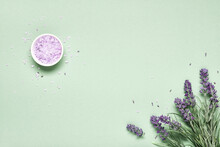 Lavender Flavored Sea Salt And Bouquet Of Lavender On Mint Green Background. Aromatherapy Treatment And Skincare Spa Cosmetics Concept