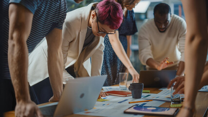 Wall Mural - Diverse Multi-Ethnic Team of Professional Businesspeople Meeting in the Modern Office Conference Room. Creative Team Around Table Discuss Design, Plan Marketing Compain, Social Media Strategy