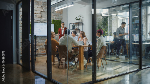 Obraz Dibond Office Conference Room Meeting: Female Chief Executive Talking to a Diverse Team of Professional Businesspeople. Creative People Listen to CEO Discuss Design, Data Analysis, Plan Marketing Strategy