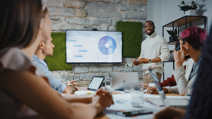 Aufkleber - Office Conference Room Meeting: Black Chief Company Strategist Doing TV Presentation to a Diverse Team of Multi-Ethnic Professional Businesspeople, Explaining Marketing Strategy, Data Analysis