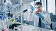 © Gorodenkoff - Male Microbiologist in Safety Glasses Adding Biological Nutritional Supplement, Vitamins and Minerals from a Syringe to a Tomato. Medical Scientist Working in a Modern Food Science Laboratory.