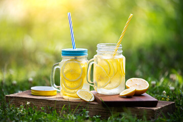 refreshing cold lemonade in a jar on a sunny meadow