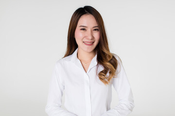 Young and beautiful healthy Asian woman with a friendly smiley face and positive happy pose on a plain background. Concept for joy, proud, self-confident, and successful female in business and life