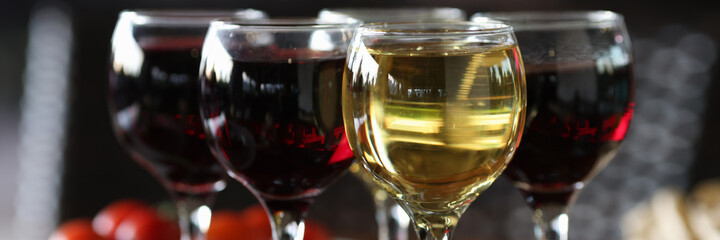 Four glasses of wine are on festive table. Professional table setting. Reserving table in cafe.