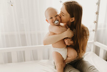 Happy Family, Child And Parenting Concept, Young Mom Hugs Her Little Child