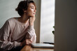 © Drobot Dean - Focused beautiful girl sitting and looking out window at home