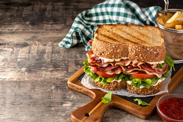 Wall Mural - BLT sandwich with bacon,lettuce and tomato on wooden table.Copy space