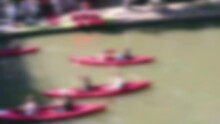 Abstract Blurred People In Canoes Paddling Down A Canal For Fun Sporting Activity In Sunshine