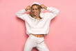 © kiuikson - Beautiful smiling blonde woman wear of white set of track suit isolated on pastel background