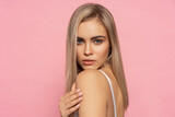 Portrait of beautiful blonde woman with long straight hair over pastel background