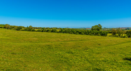 An ancient ridge and furrow ploughed field beside the Grand Union Canal in Market Harborough in summertime