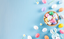 Happy Easter! Colourful Of Easter Eggs In The Nest With Rabbit On Pastel Blue Background. Greetings And Presents For Easter Day Celebrate Time. Flat Lay ,top View.