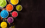 Happy holi festival decoration.Top view of colorful holi powder on dark background with copy space for text.