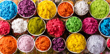 Happy Holi Decoration, The Indian Festival.Top View Of Colorful Holi Powder On Dark Background.