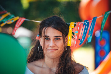 Nice teenager is celebrating her  birthday near balloons