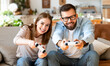 © JenkoAtaman - couple laugh and play video games together using a video game console