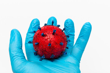 Wall Mural - Closeup shot of the Doctor's hand holding a red virus ball on a white background