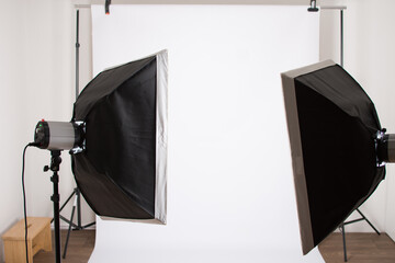 Studio with two soft box on stand and white background. Studio lightening and photography. Behind the scene.