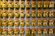 © Anna - A wall with many Lucky Cats Maneki-Neko front view.
