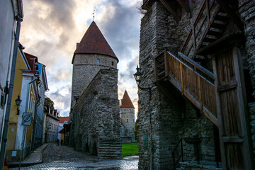 Wall Mural - old town wall with towers after a storm in autumn 