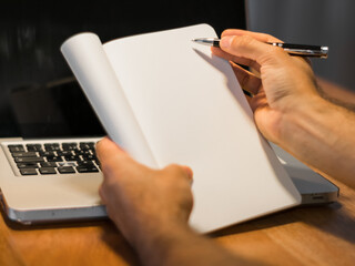 person writing on notebook with a pen