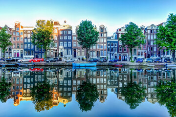 Wall Mural - Reflections of iconic buildings along an Amsterdam canal