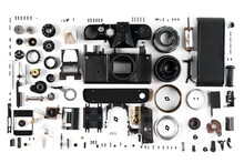 Top View Of A Disassembled Film Camera, The Details Of Which Are Meticulously Laid Out On A White Surface