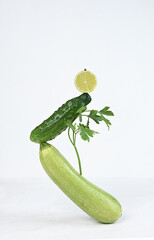 Vegetable art composition - abstract balancing construction of fresh green vegetables. Avant garde, modern visual art, fashion, minimal design, healthy food concept.