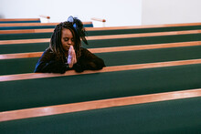 Woman Praying To God In Kingdom Church Home