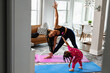 © Gerald R Carter Jr/Creative Flame - Mother and daughter doing yoga in living room