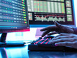 © Andrew Brookes/Westend61 - Hands of trader typing on keyboard in front of computer monitor displaying stock market data