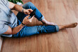 © Eva Blanco/Westend61 - Young man using mobile phone at home