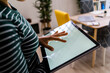 © Giorgio Fochesato/Westend61 - Young businesswoman touching screen of digital tablet at work place