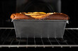 © Estefania Torres/ADDICTIVE STOCK - Side view healthy banana bread in container in oven