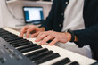 © Jake Jakab/ADDICTIVE STOCK - Crop male musician playing electric piano and composing music in creative home studio
