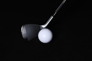 Black background, golf balls and clubs.