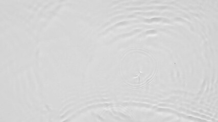 Poster - Close up top view of water droplets falling into the water and separate splashes of water on gray background in 4k slow motion.