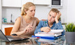 © JackF - Mother calming her daughter who upset by her studies at kitchen table