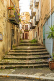 Fototapeta Uliczki - Italy, Sicily, Palermo Province, Castelbuono. Stairs on a narrow street in Castelbuono.