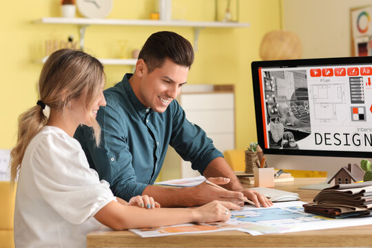 Male interior designer with client in his office