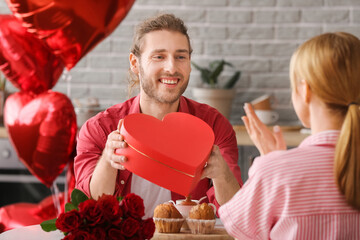 Sticker - Young man greeting his girlfriend on Valentine's Day at home