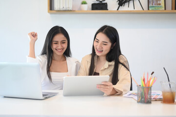 Two businesswoman feeling happy and celebrate successful business.