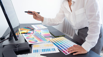 Poster - creative graphic designer choosing color scale for editing artwork while working in office.